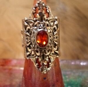 Intricate Silver Ring with Fiery Orange Gemstone